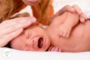 mothercare, young mother calms her newborn baby during she is cr