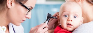 Pediatrician using otoscope