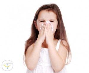Ill child blowing her nose
