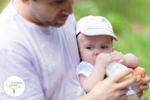 Father feeding his baby from the bottle