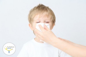 child blowing his nose