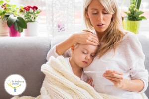 Mother checking temperature of her sick child