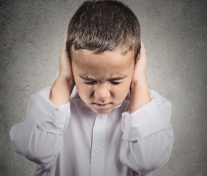 Boy Covers his Ears, hear no evil concept